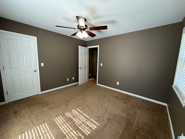 unfurnished bedroom featuring carpet and ceiling fan