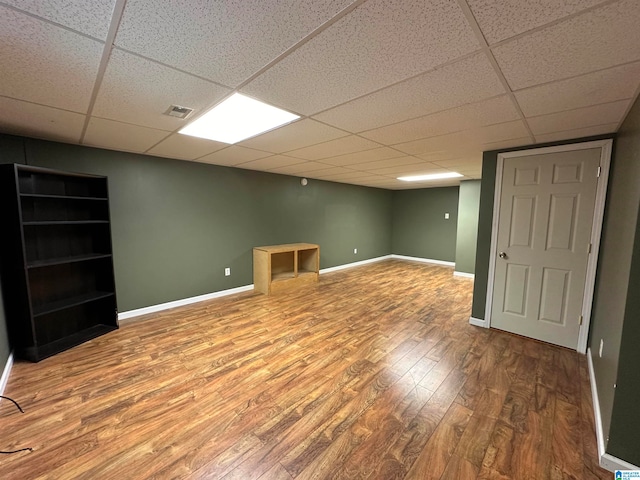 basement with wood-type flooring and a drop ceiling