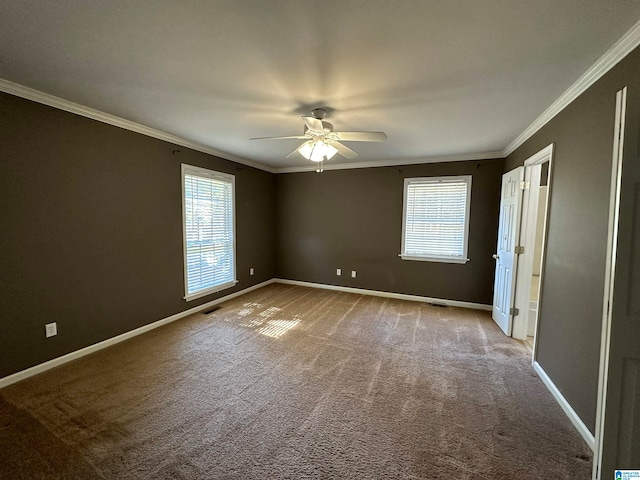 carpeted spare room featuring crown molding and ceiling fan