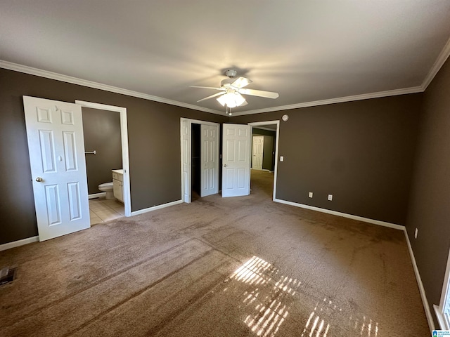 unfurnished bedroom featuring ensuite bathroom, crown molding, light colored carpet, and ceiling fan