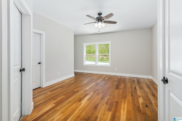 unfurnished bedroom with ceiling fan and hardwood / wood-style flooring