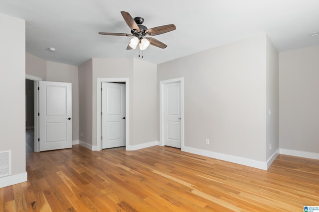 unfurnished bedroom with ceiling fan and hardwood / wood-style flooring