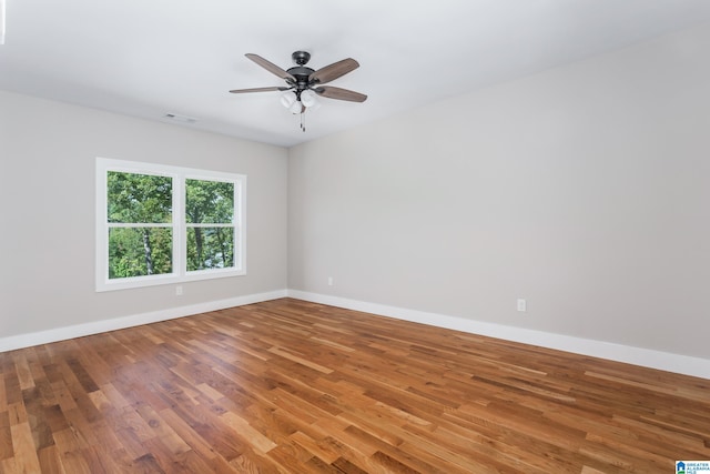 empty room featuring wood-type flooring and ceiling fan