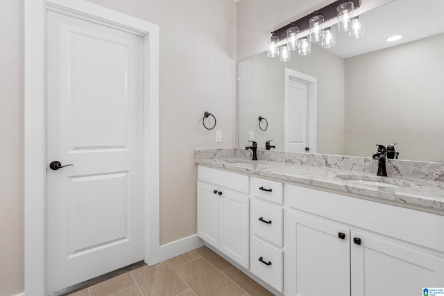 bathroom featuring tile patterned flooring and vanity