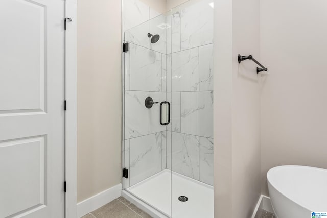 bathroom with tile patterned floors and independent shower and bath