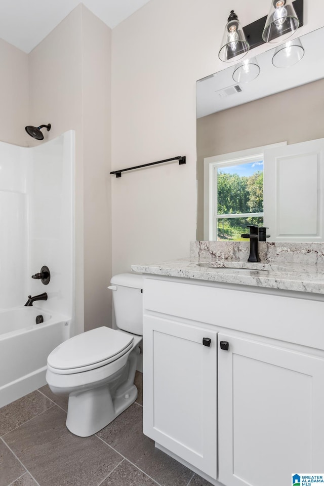 full bathroom featuring  shower combination, tile patterned floors, vanity, and toilet