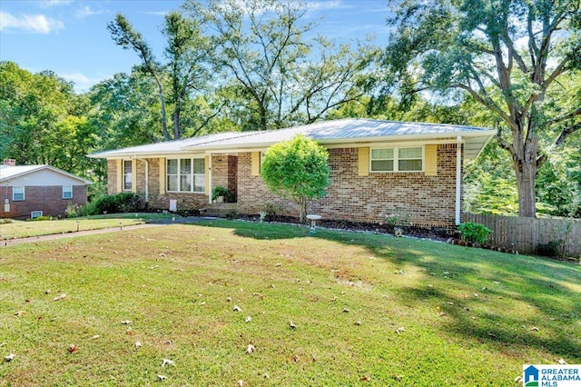 ranch-style home featuring a front yard