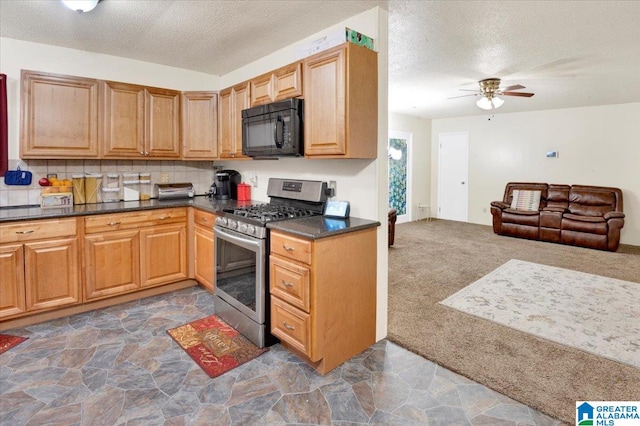 kitchen featuring ceiling fan, stainless steel gas range, dark carpet, and a textured ceiling