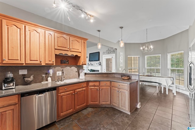 kitchen featuring a chandelier, sink, stainless steel dishwasher, and decorative light fixtures