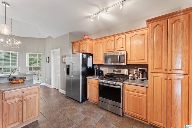 kitchen with backsplash, a chandelier, dark tile patterned floors, pendant lighting, and stainless steel appliances