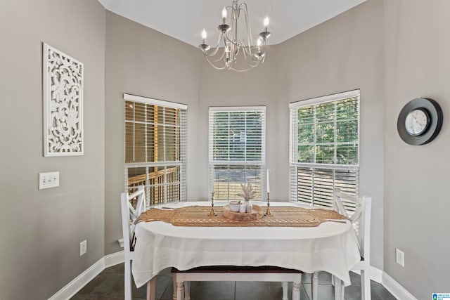 tiled dining area featuring a chandelier