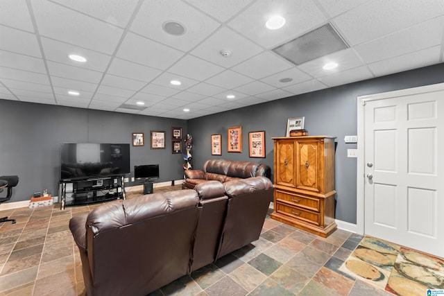 living room featuring a paneled ceiling