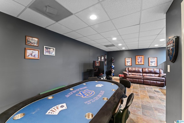 recreation room featuring a paneled ceiling