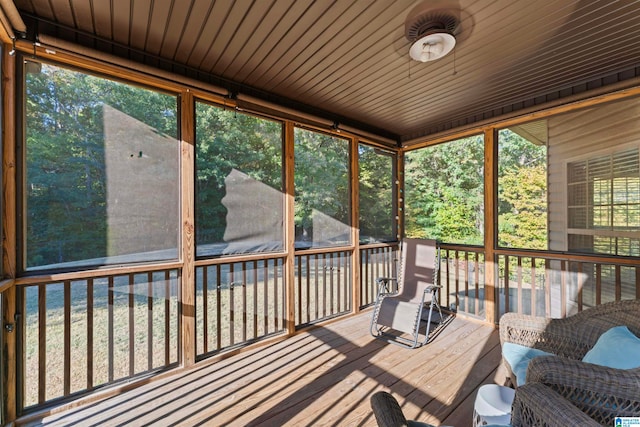 unfurnished sunroom with a wealth of natural light and wooden ceiling