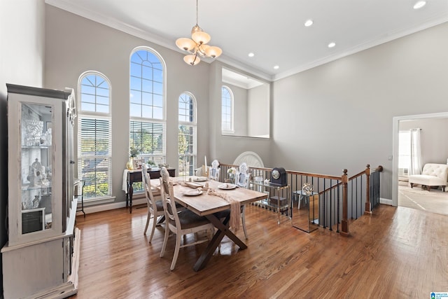 dining room featuring crown molding, a wealth of natural light, and hardwood / wood-style floors