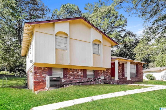 view of front of house with a front yard and cooling unit