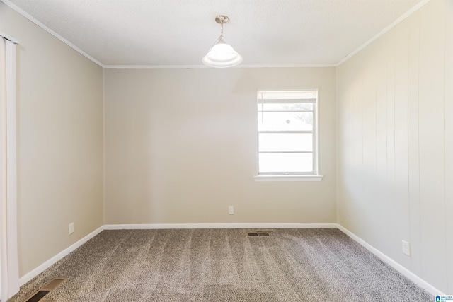 carpeted empty room featuring crown molding