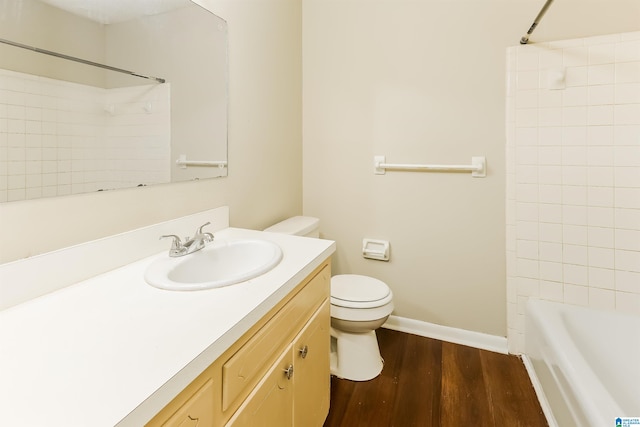 full bathroom with vanity, toilet, wood-type flooring, and tiled shower / bath combo