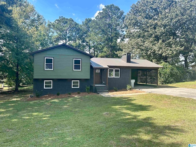 tri-level home with a front lawn and a carport