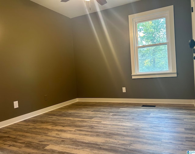 empty room with hardwood / wood-style floors and ceiling fan