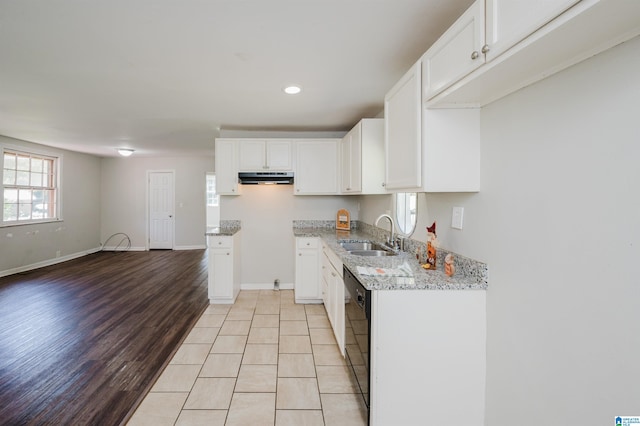 kitchen featuring light stone counters, white cabinets, light hardwood / wood-style flooring, and sink