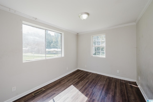 spare room featuring crown molding and dark hardwood / wood-style flooring