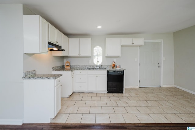 kitchen with light stone counters, black dishwasher, sink, and white cabinetry