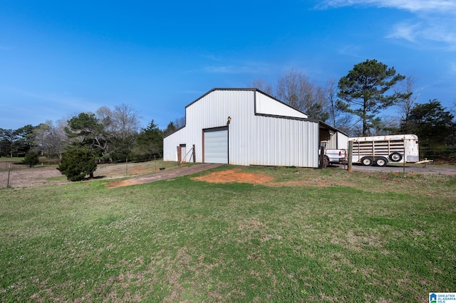 view of outdoor structure with a garage and a yard