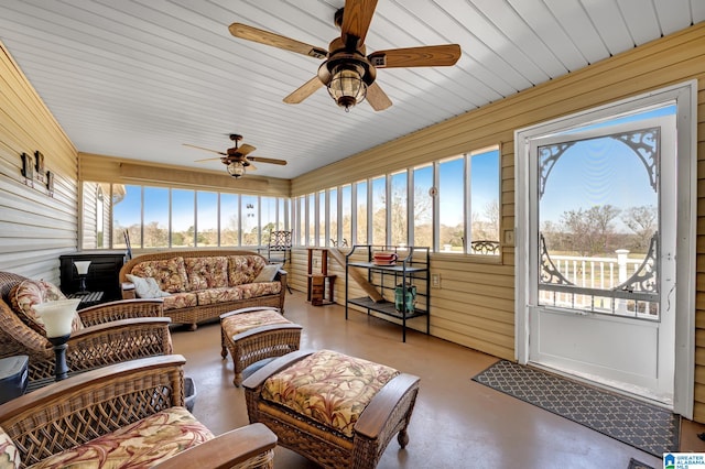 sunroom featuring ceiling fan