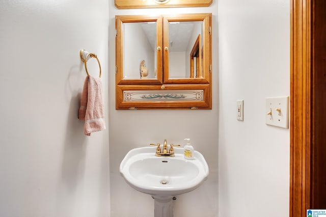 bathroom featuring a textured ceiling and sink