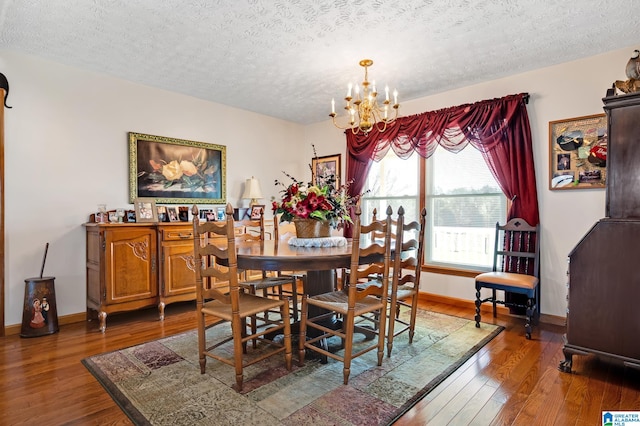 dining room featuring an inviting chandelier, a textured ceiling, and dark wood-type flooring