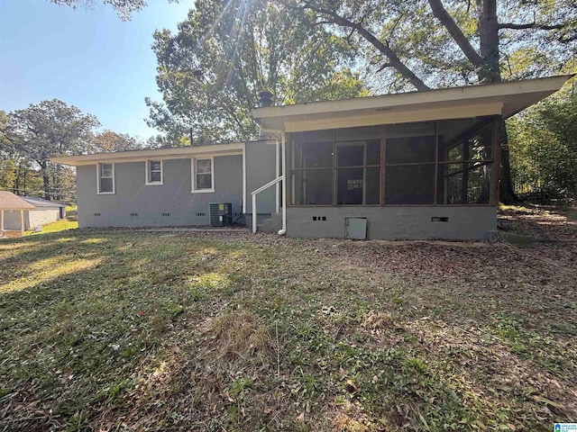 back of property with cooling unit, a sunroom, and a yard