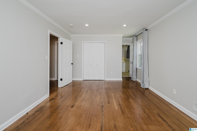 unfurnished bedroom featuring a closet, dark wood-type flooring, and ornamental molding