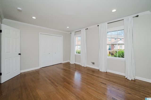 unfurnished bedroom featuring ornamental molding and dark hardwood / wood-style flooring