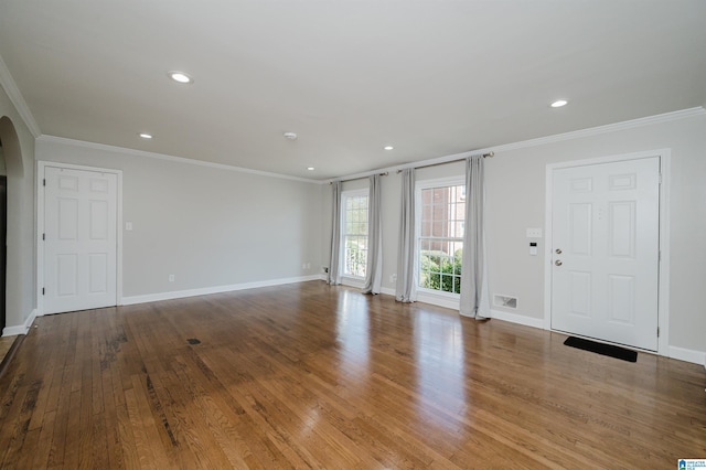 unfurnished living room featuring light hardwood / wood-style floors and crown molding