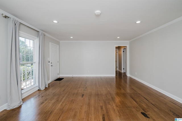 empty room featuring hardwood / wood-style flooring and crown molding