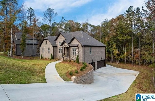 view of front of property with a garage and a front lawn