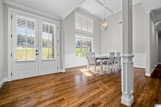 dining space with a chandelier, french doors, dark wood-type flooring, and ornamental molding