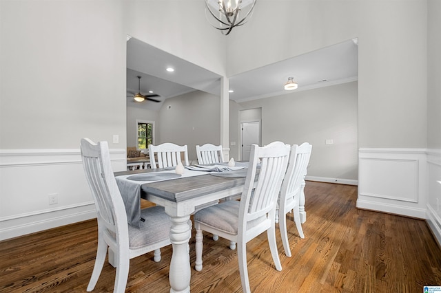 dining space with hardwood / wood-style floors, ceiling fan with notable chandelier, and crown molding