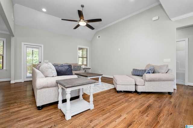 living room with lofted ceiling, ceiling fan, wood-type flooring, and ornamental molding