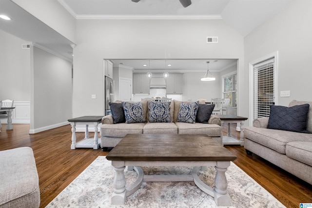 living room featuring lofted ceiling, ceiling fan, dark hardwood / wood-style floors, and ornamental molding