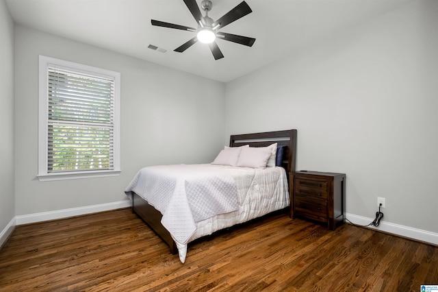 bedroom featuring ceiling fan and dark wood-type flooring