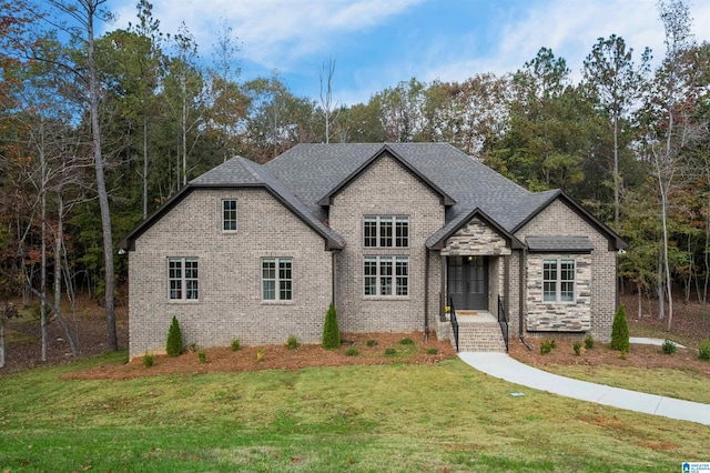 french provincial home featuring a front lawn