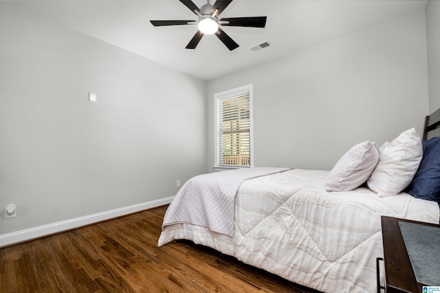 bedroom featuring ceiling fan and dark wood-type flooring