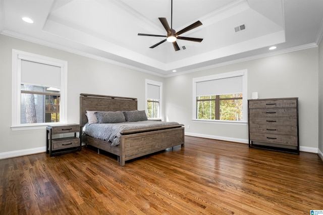 bedroom with a raised ceiling, ceiling fan, crown molding, and dark hardwood / wood-style floors