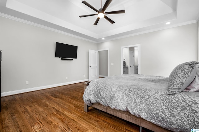 bedroom featuring hardwood / wood-style floors, a raised ceiling, ceiling fan, and ornamental molding