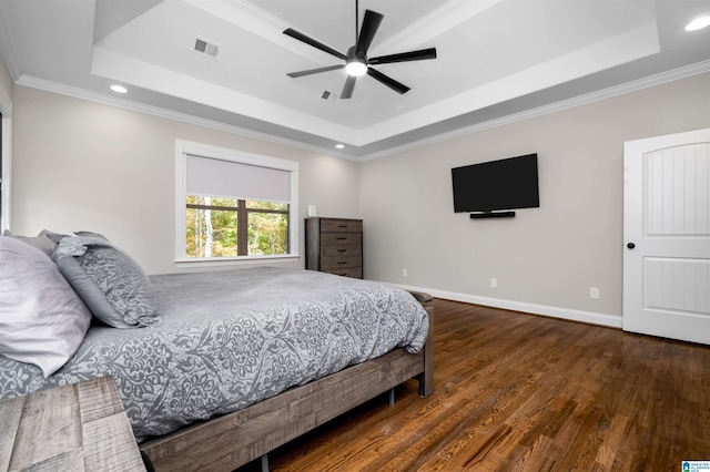 bedroom with a raised ceiling, ceiling fan, dark hardwood / wood-style floors, and ornamental molding