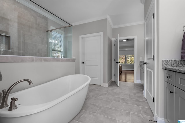 bathroom with plus walk in shower, vanity, tile patterned floors, and ornamental molding