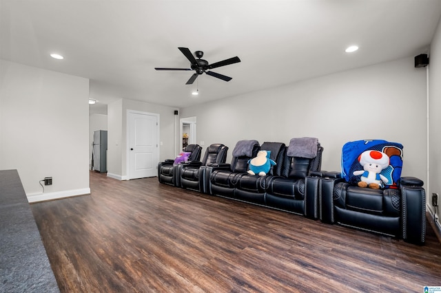 home theater room featuring dark hardwood / wood-style floors and ceiling fan