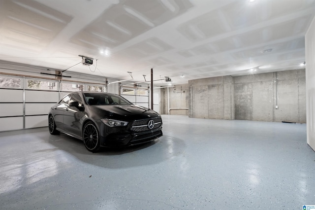 garage with a garage door opener and a carport